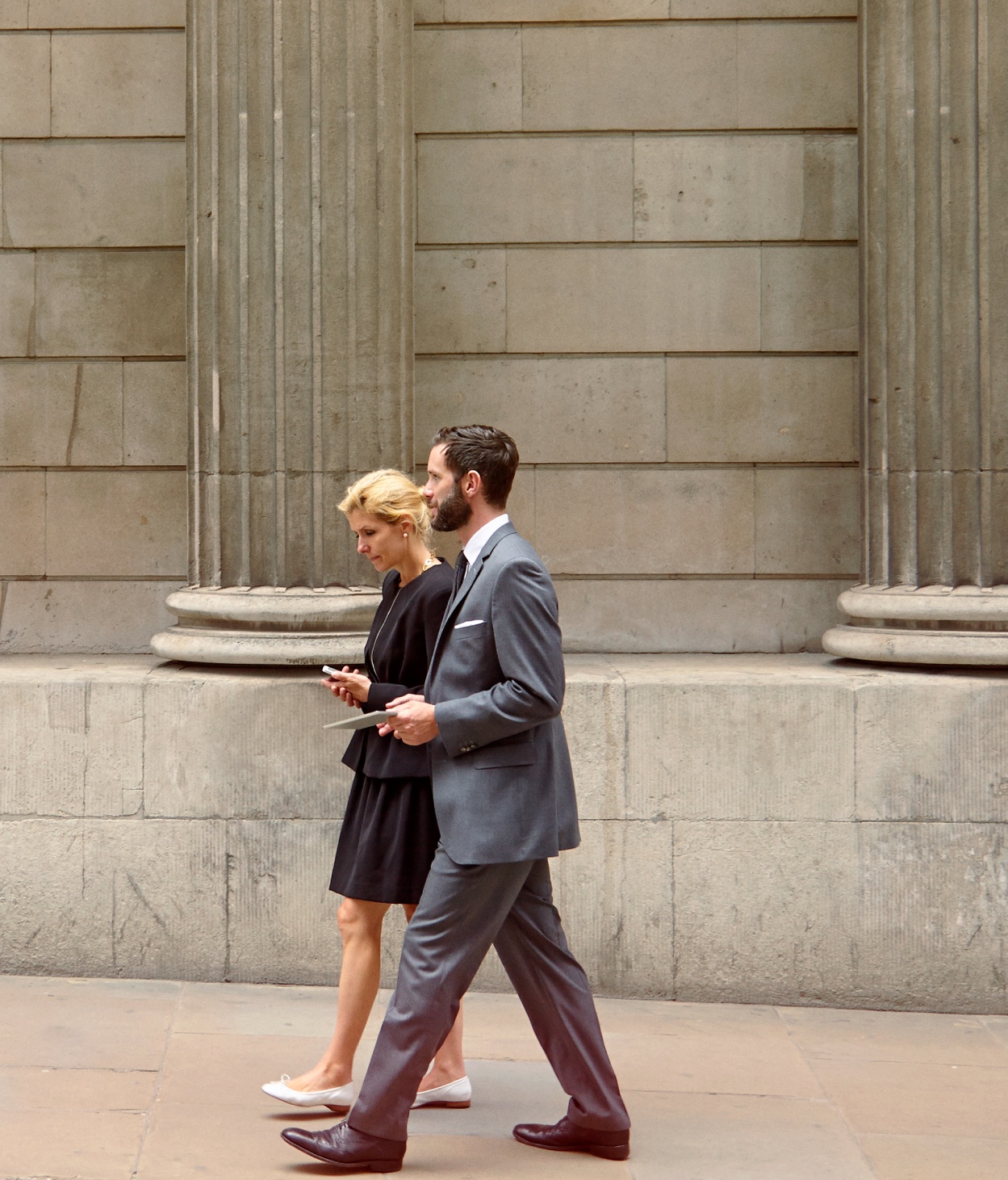 Male and female lawyers walk in front of the courthouse