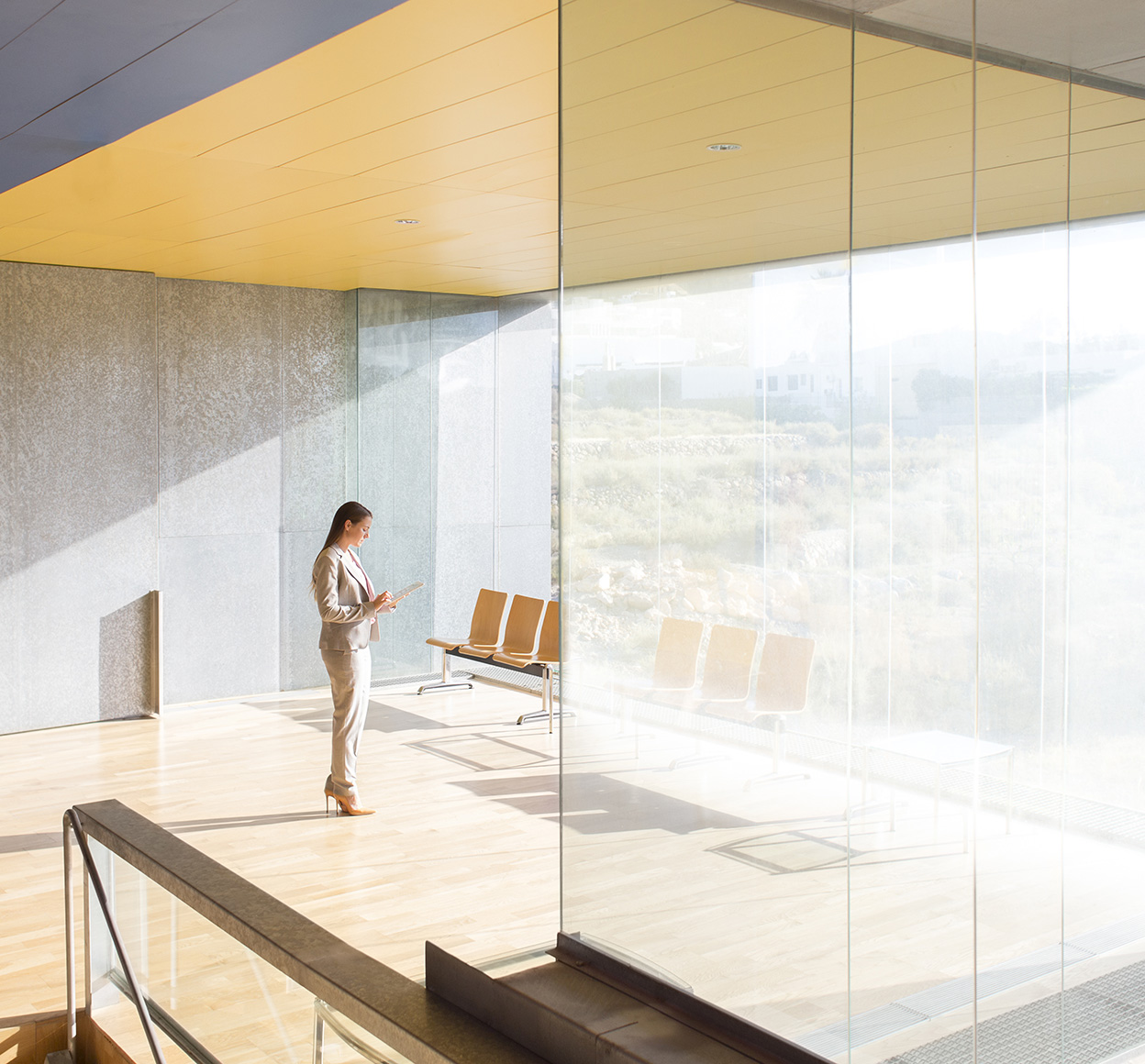 Businesswoman standing in sunny office