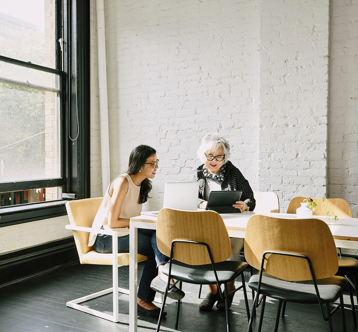 Businesswomen hold a remote conference from an office.