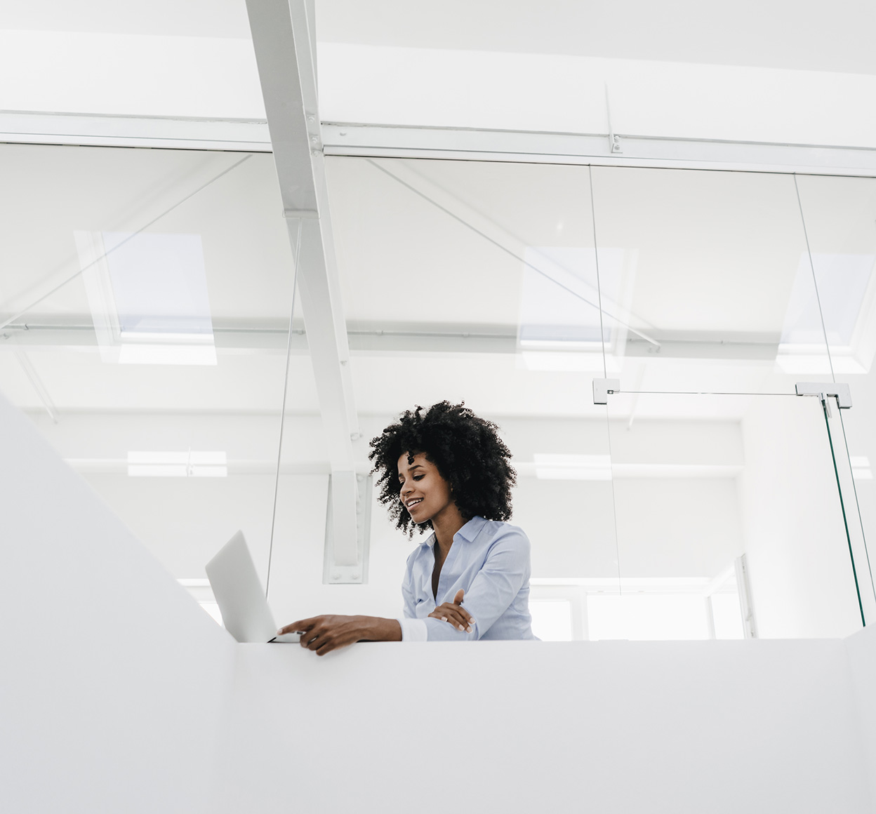 woman standing up looking at laptop